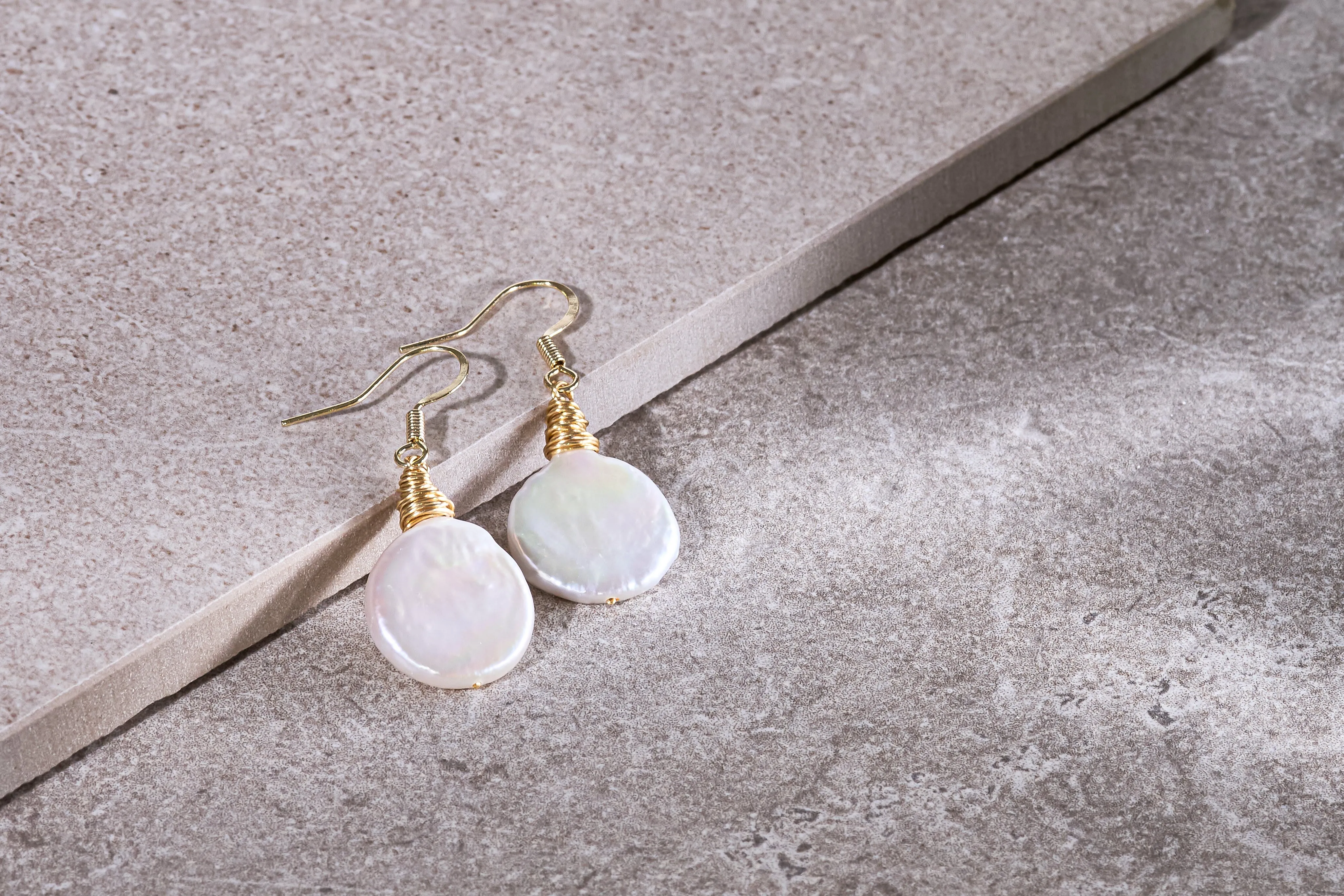 Credo coin pearl earrings set in gold wirework