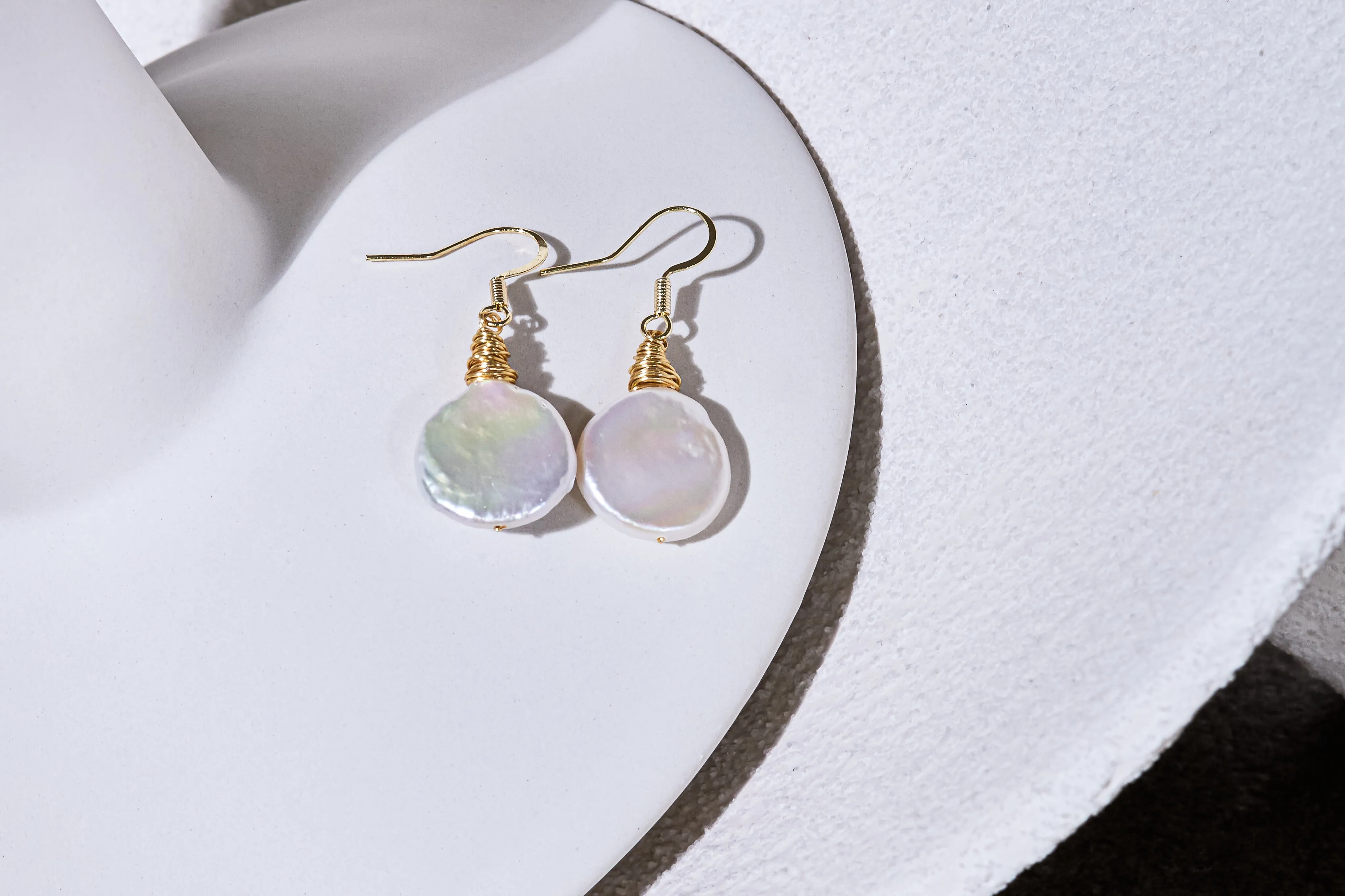 Credo coin pearl earrings set in gold wirework